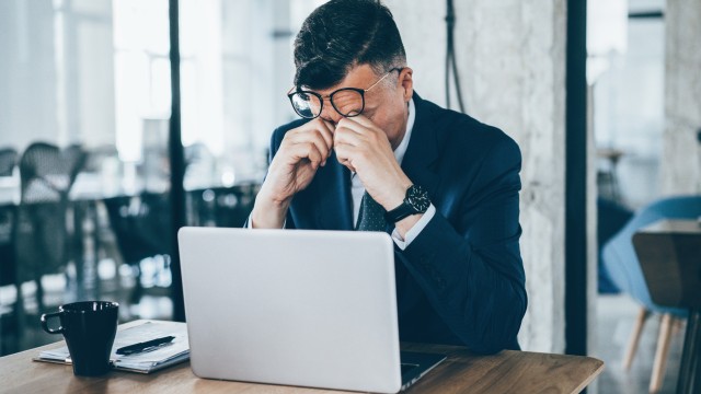 Office worker sitting in front of laptop