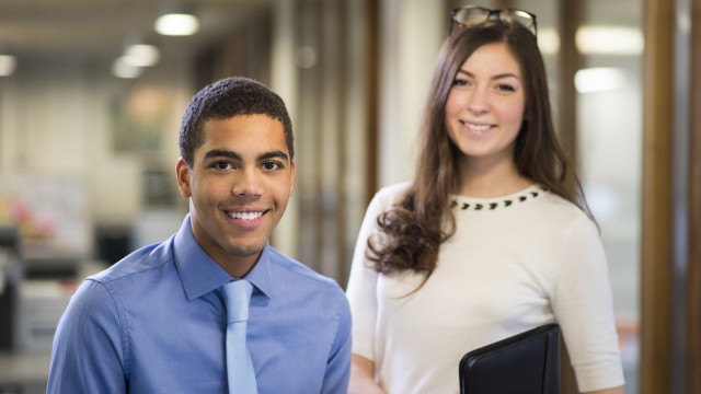 Two university students pictured in a modern office