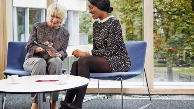 Two women looking at tablet