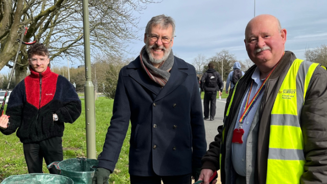 Three members of staff litter picking on campus