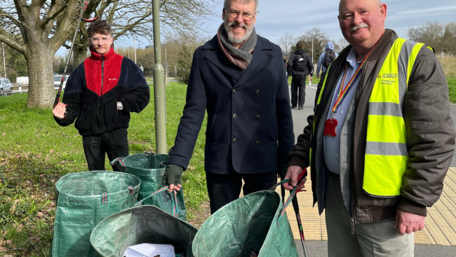 Three members of staff litter picking on campus