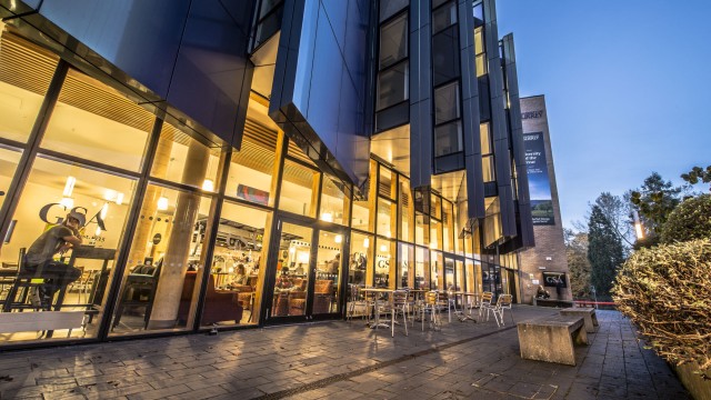 Exterior of the Guildford School of Acting building at dusk