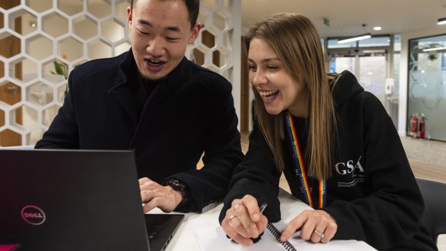 Two students studying in the HIVE at a laptop