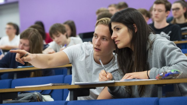 Male and female students in a lecture theatre