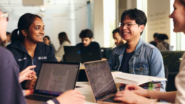 Students studying and smiling in library