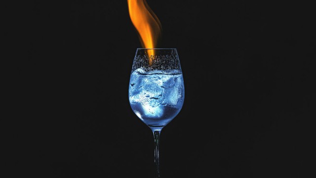 Fire going into glass filled with icy water