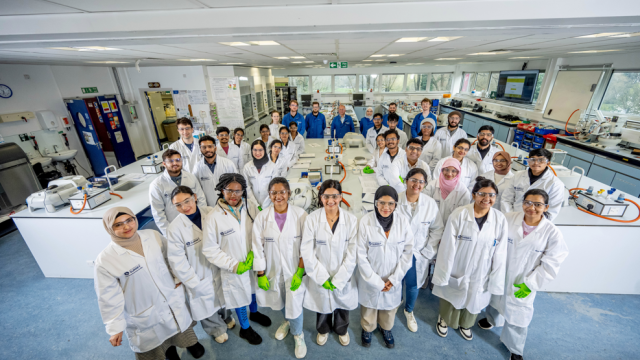 view of students posing for a picture in a lab at Surrey
