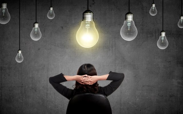 Woman underneath lightbulbs