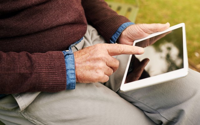 Elderly man using a tablet