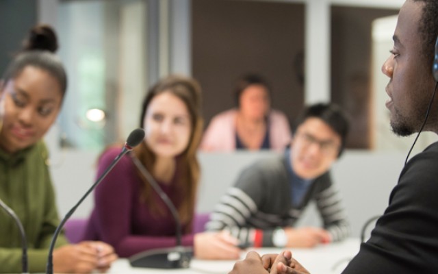 Group of students sat around a table