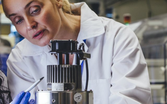 Two female engineers working on a metallic object