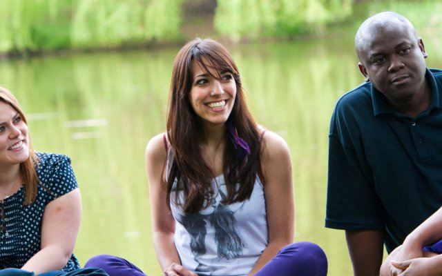Students sitting by the lake.