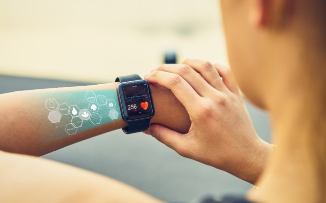 Woman using a watch with heart monitor app