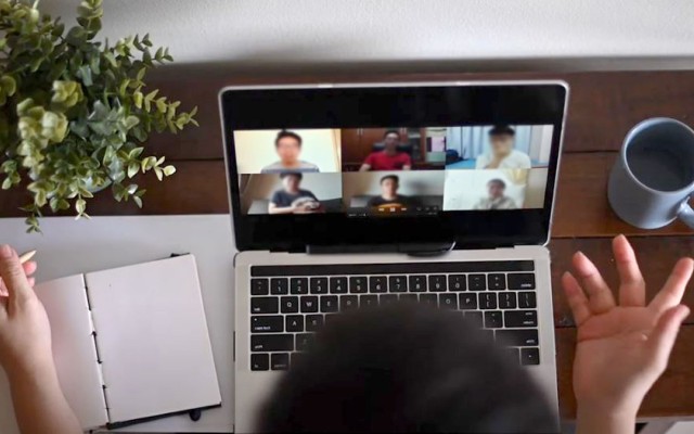 Person talking to others online via their laptop
