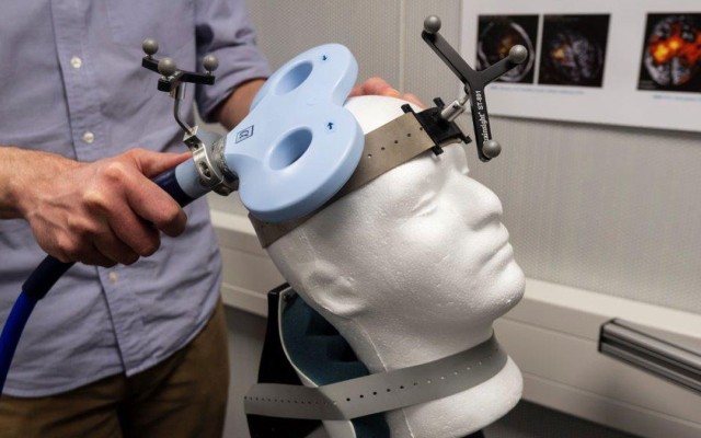 Person using equipment to monitor brain behaviour