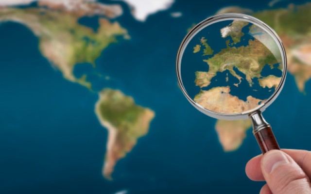 Magnifying glass over European map 
