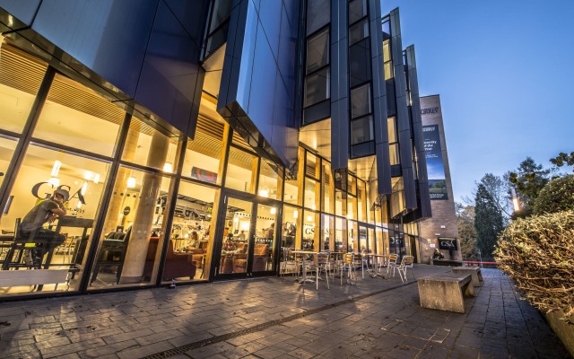Exterior of the Guildford School of Acting building at dusk