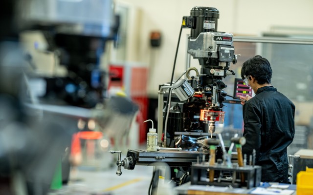 Student works on machines in engineering workshop