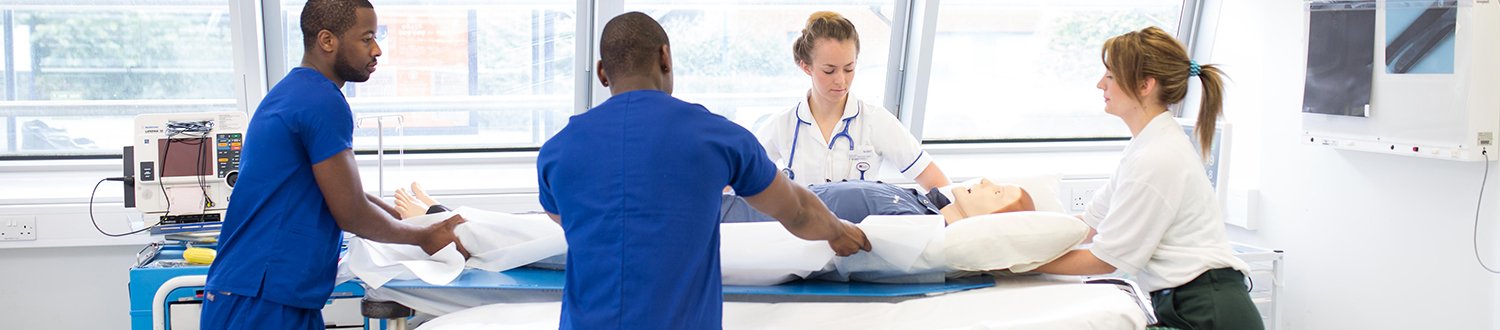 a group of health sciences students in the simulation suite