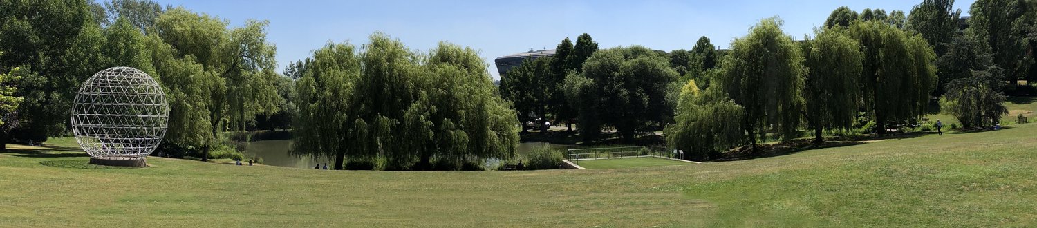 Panoramic photo of the campus by the lake with the globe