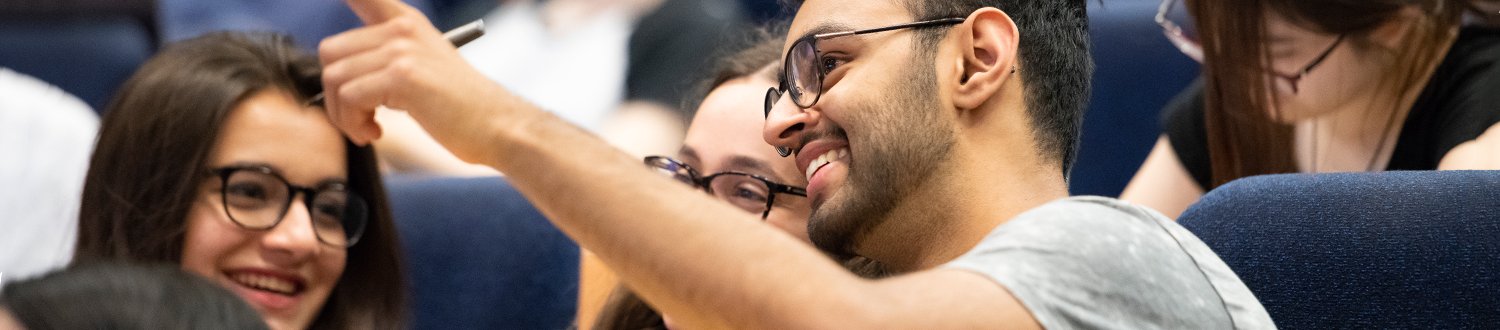 Students in a lecture theatre learning about economics
