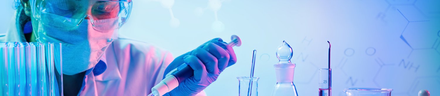 Woman in a lab using a pipette