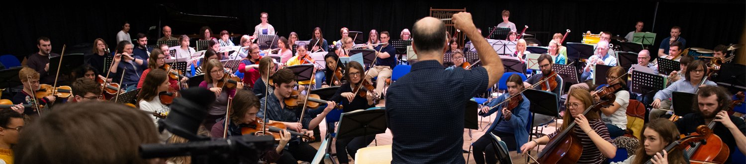 Orchestra surrounding composer