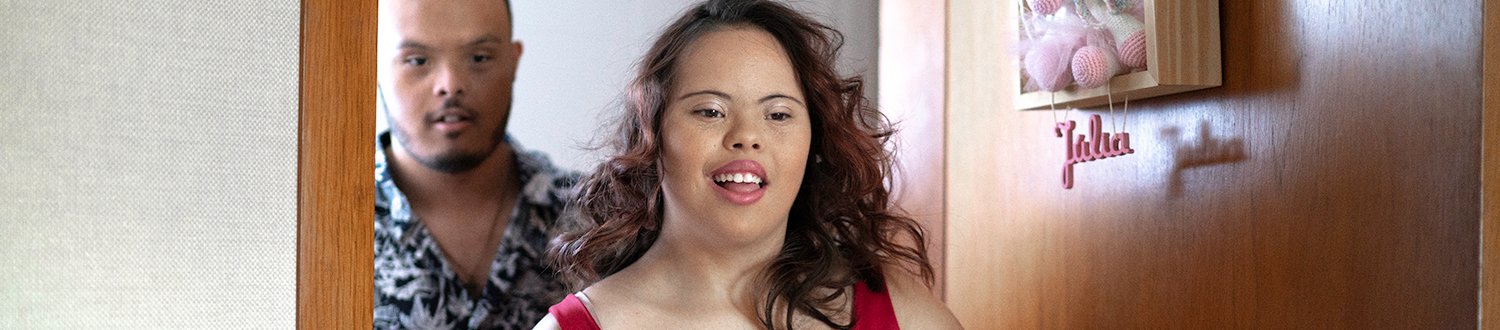 A special needs couple opening baby room's door.