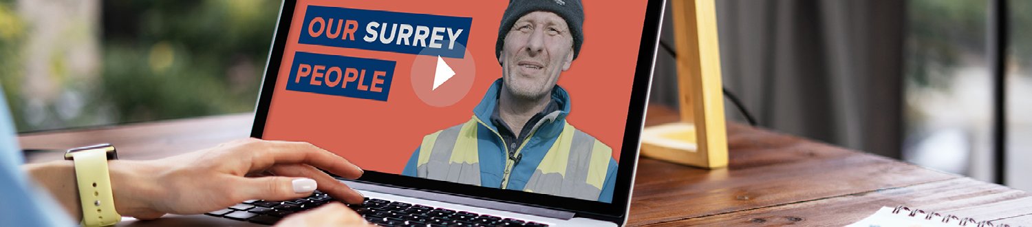 A person is looking an Our Surrey People campaign video on a laptop