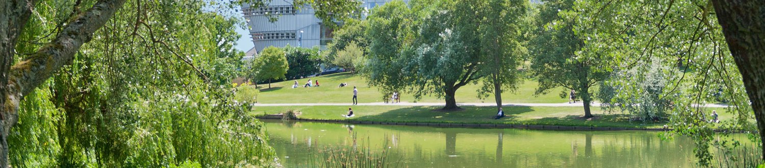 University campus by the lake with the Duke of Kent building in the background