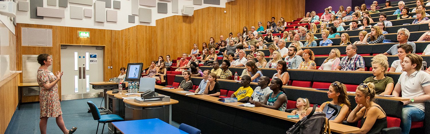 Speaker talking to audience in lecture theatre