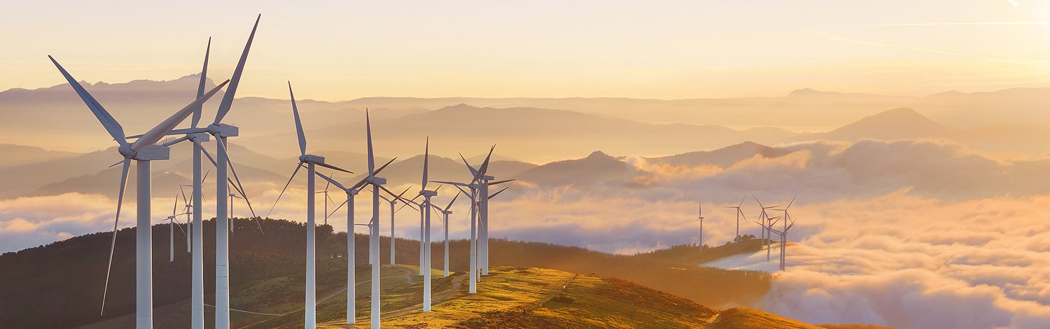 Wind turbines on a hill at sunset