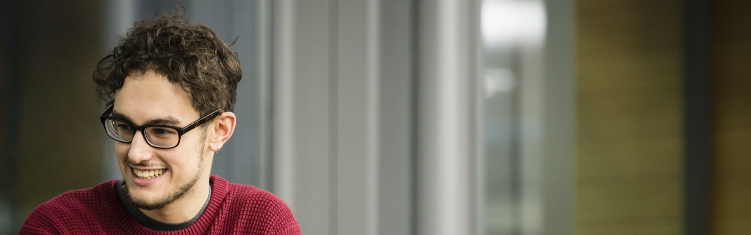 Student in a red jumper smiling