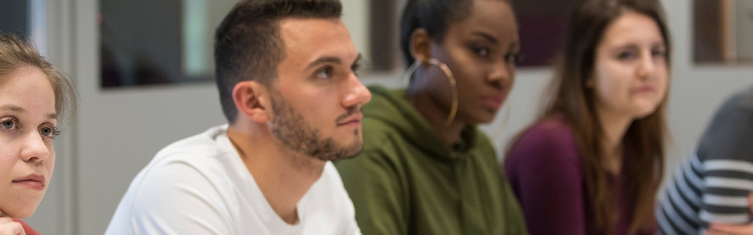 a row of attentive students in class