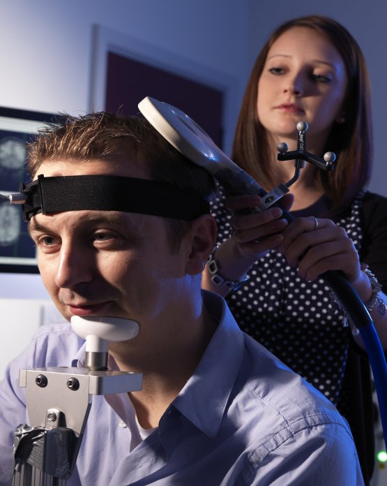 Person carrying out psychology test on another person using equipment