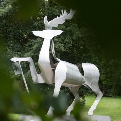 The university stag statue with leaves in the foreground