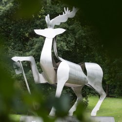 The university stag statue with leaves in the foreground