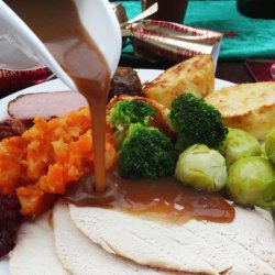 Gravy being poured over a roast dinner
