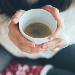 Hands holding a mug of coffee