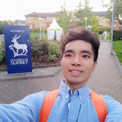 Huan Huang at the gate of the University of Surrey