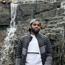 Picture of Auwal with waterfall as background
