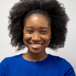Image of black female with a blue blouse and Afro