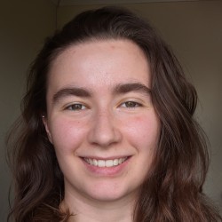 A front-on image of me. I have brown wavy hair and greenish eyes.