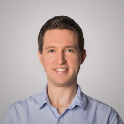 White male with brown hair wearing a blue shirt facing the camera