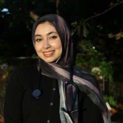 Elaaf smiles at the camera outside