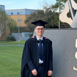 Engineering student on posing graduation day 