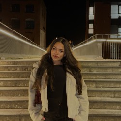 Photo of Nina, Environment and Sustainability student at Surrey, with hands in their pockets.