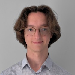 Male student smiling over white background