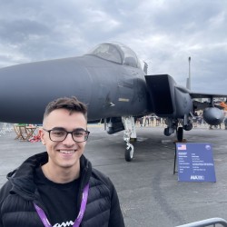 Student standing in front of an aircraft