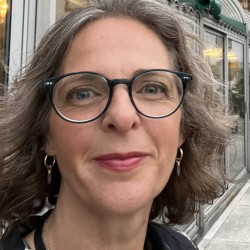 Sarah smiles at the camera in a selfie outside.